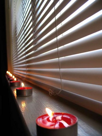 An incredible image of some candles with blinds close to them